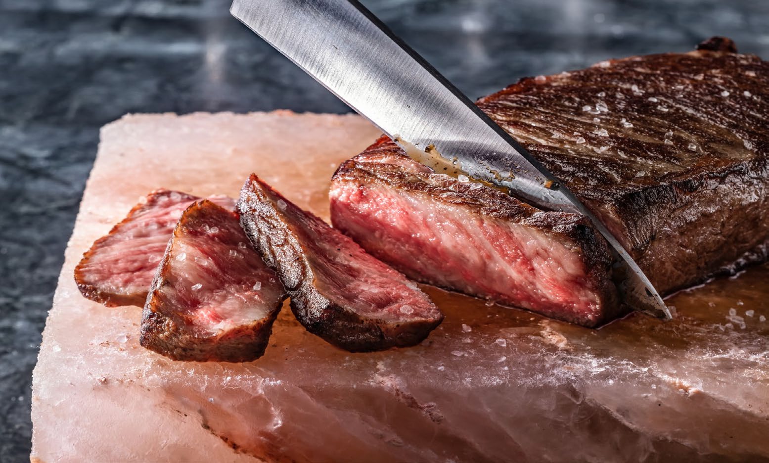 Knife cutting into steak