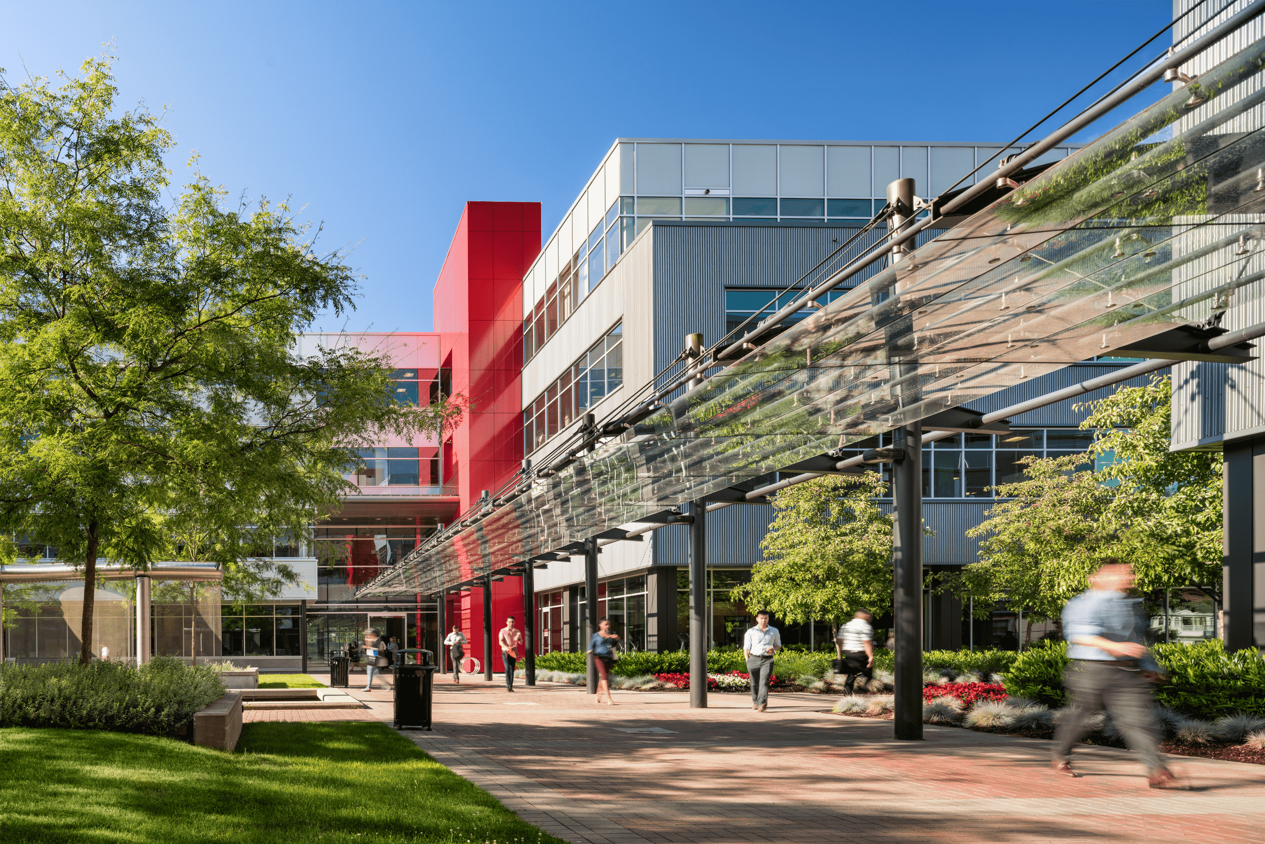 People walking on the sidewalk with a backdrop of a building